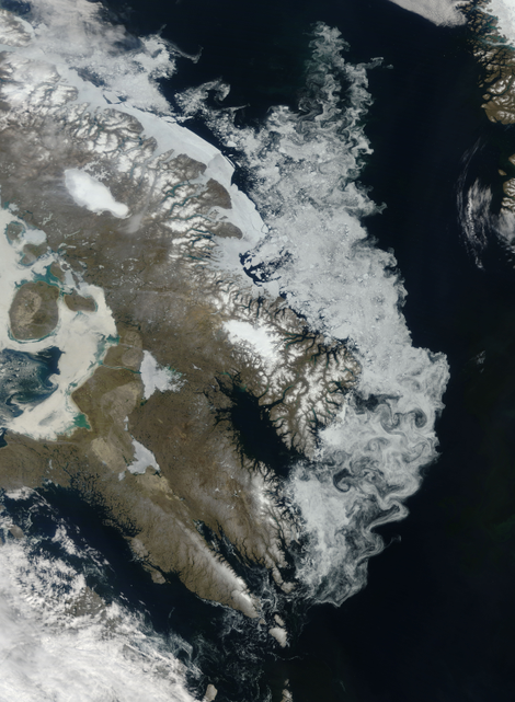 Satellite image of Canada’s Baffin Island. The Barnes Ice Cap is the elliptical ice sheet in the center of the island in the upper left. Image: NASA Earth Observatory